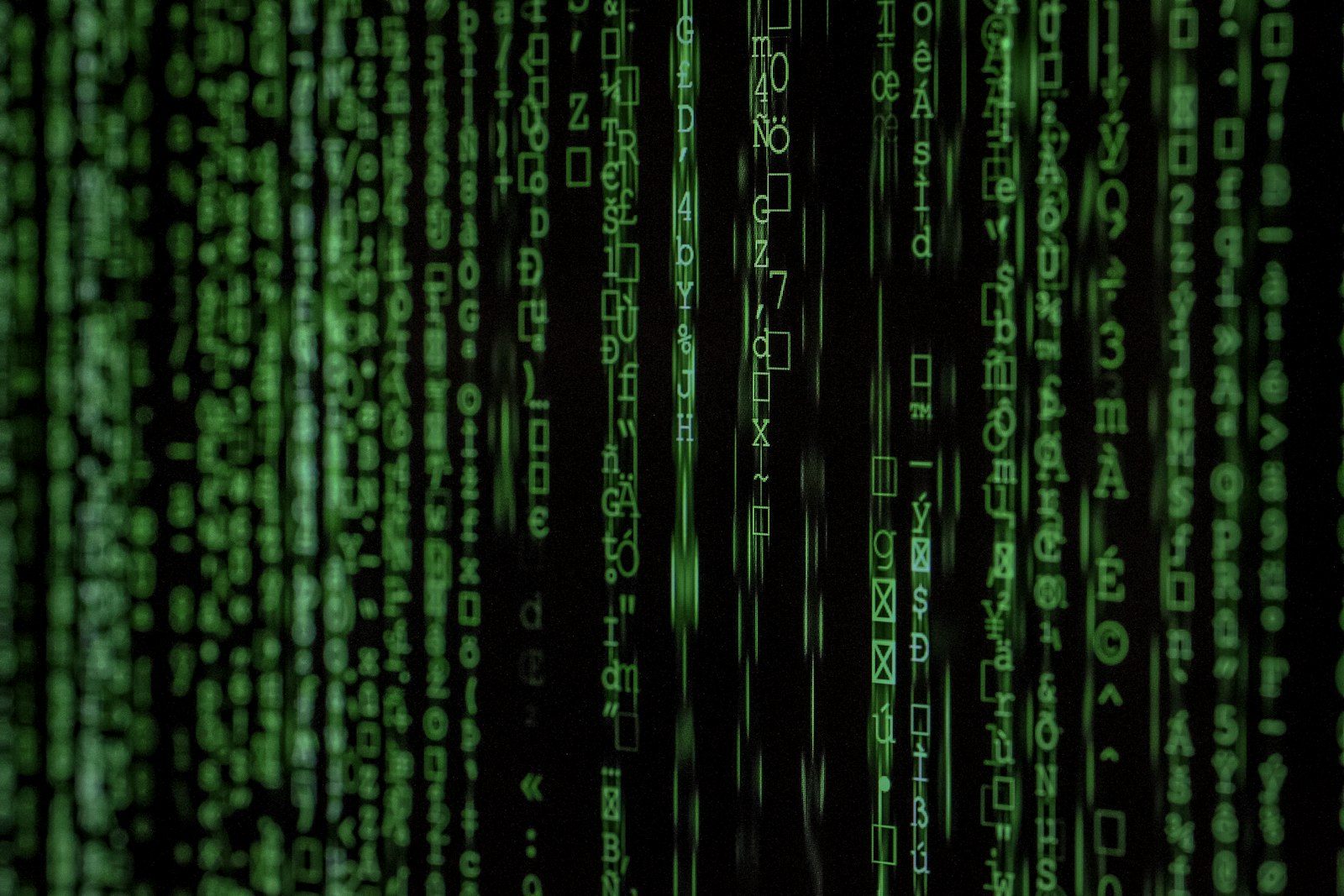 Green code streaming down a dark screen